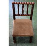 An Arts and Crafts oak child's chair, bobbin turned back and forelegs,