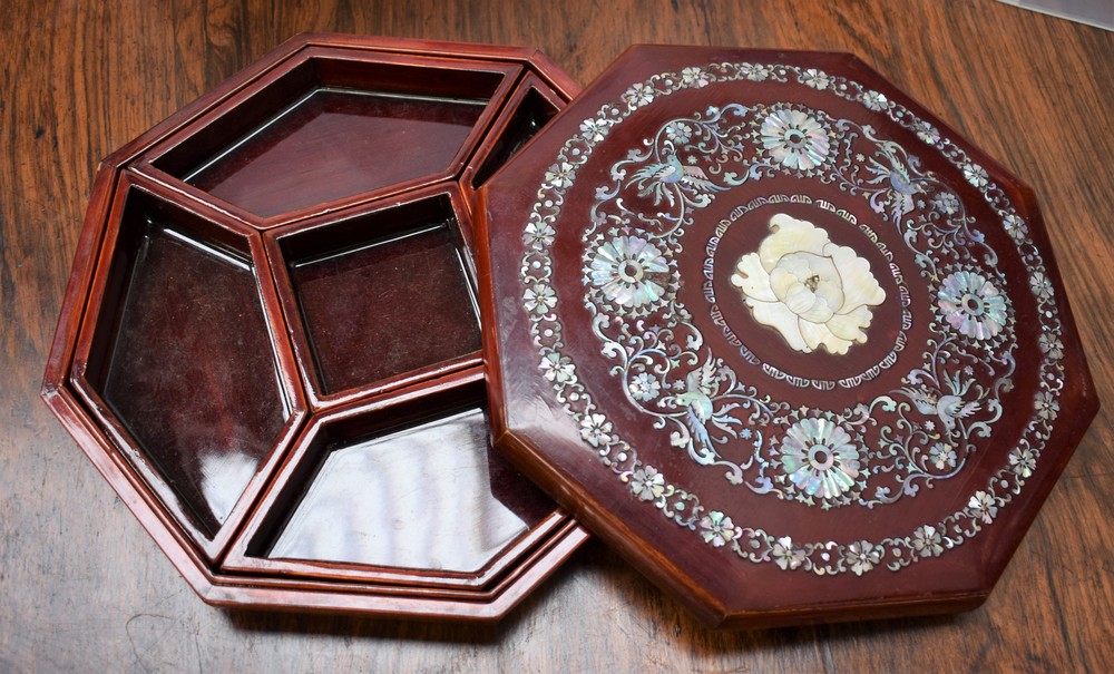 A Chinese lacquer and mother of pearl octagonal box, lift-off cover applied with chrysanthemums,