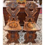 A pair of sgabello type hall chairs,