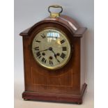 An Edwardian mahogany inlaid bracket clock, circular face with Roman numerals, minute track,