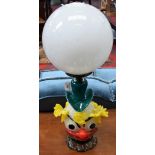 A Murano glass table lamp as a clowns head, with large white glass spherical shade,