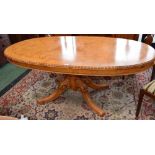 A Victorian style dining table, elliptical top with moulded egg and dart border above a deep frieze,