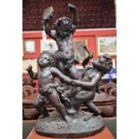 French School, a substantial dark patinated bronze, of revelling Bacchic putti, traces of verdigris,