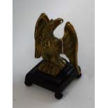 An early 19th century gilt and dark patinated bronze desk model, of an Imperial eagle, square base,