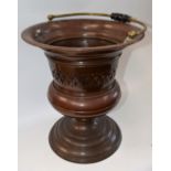 A pierced copper planter/jardiniere, brass and turned ebonsied swing handle,