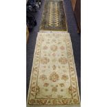 A pair of Ziegler design Pakistan wool throw rugs on fawn ground, 140cm x 73cm; a runner,