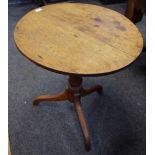 A George III oak tripod table, circular top, turned column, circa 1830. 68cm high x 63cm diameter.