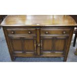An Ercol sideboard, oversailing top, two short drawers over two door cupboard, stile feet.