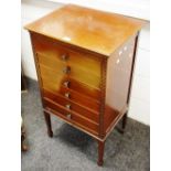An Edwardian mahogany six drawer music cabinet, moulded top, tapering square legs, spade feet,