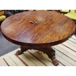 A William IV flame mahogany centre table, circular top, turned column, incurved triform base,