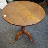 A George III oak tilt top occasional table, circular top, turned column, cabriole legs, pad feet.
