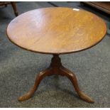 A George III oak occasional table, circular top, turned column, cabriole legs, pad feet.