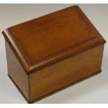 A late Victorian oak slope top stationery box,