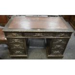 A dark oak pedestal desk, leather inlaid top, one long drawer and two short to frieze,