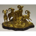 A substantial cast brass figure group of 4 mountain goats on a rocky outcrop,