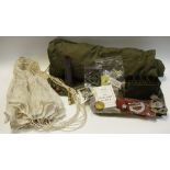 Military interest - an army issue green canvas sleeping bag; a small pilot cargo parachute;
