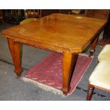 An Arts and Crafts mahogany wind out table, moulded top, canted angles, tapering square legs,