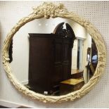 A large contemporary oval wall mirror,
