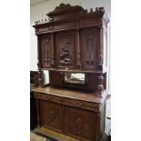 A Flemish oak cupboard, shaped pediment,
