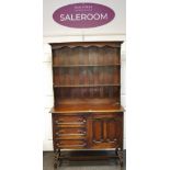 A 1930's oak dresser, two shelves and shaped uprights to top,