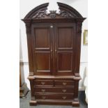 A contemporary Indonesian hardwood armoire style wardrobe, carved arched superior structure,
