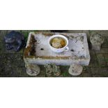 Garden ornaments - three reconstituted stone pig figures; a miniature staddle stone;