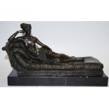 A bronzed figure of Pauline Bonaparte reclining on a chaise.