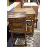 An oak priory style pot cupboard, linenfold door; an oak bedside table,