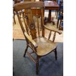 An elm spindle back chair,shaped and pierced splat, saddle seat,