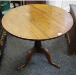 A George III oak tilt top occasional table, circular top, turned column, cabriole legs, pad feet.