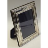 An Arts and Crafts style silver easel photograph frame,