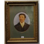 A gilt framed oval portrait of a young gentleman.