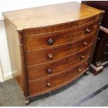 A George III bowfront chest of two short cockbeaded drawers over three long flanked by reeded