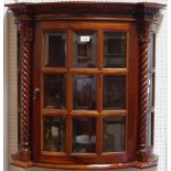 A teak bow front wall hanging display cabinet.