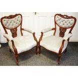 A pair of Hepplewhite style open armchairs, shaped button upholstered back, padded arms and seat,