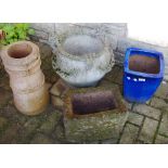 A small hewn stone trough; a reconstituted stone three handled planter decorated with swags;