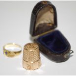 A 19th century gold coloured ring set with sapphire; gold coloured thimble, c.