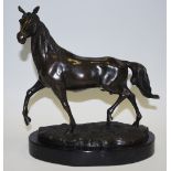 A cast bronze patinated figure of a horse.