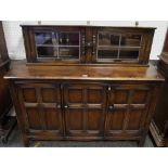 An oak sideboard oversailing top, three panelled door cupboard to base,