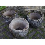 Three hewn stone planters