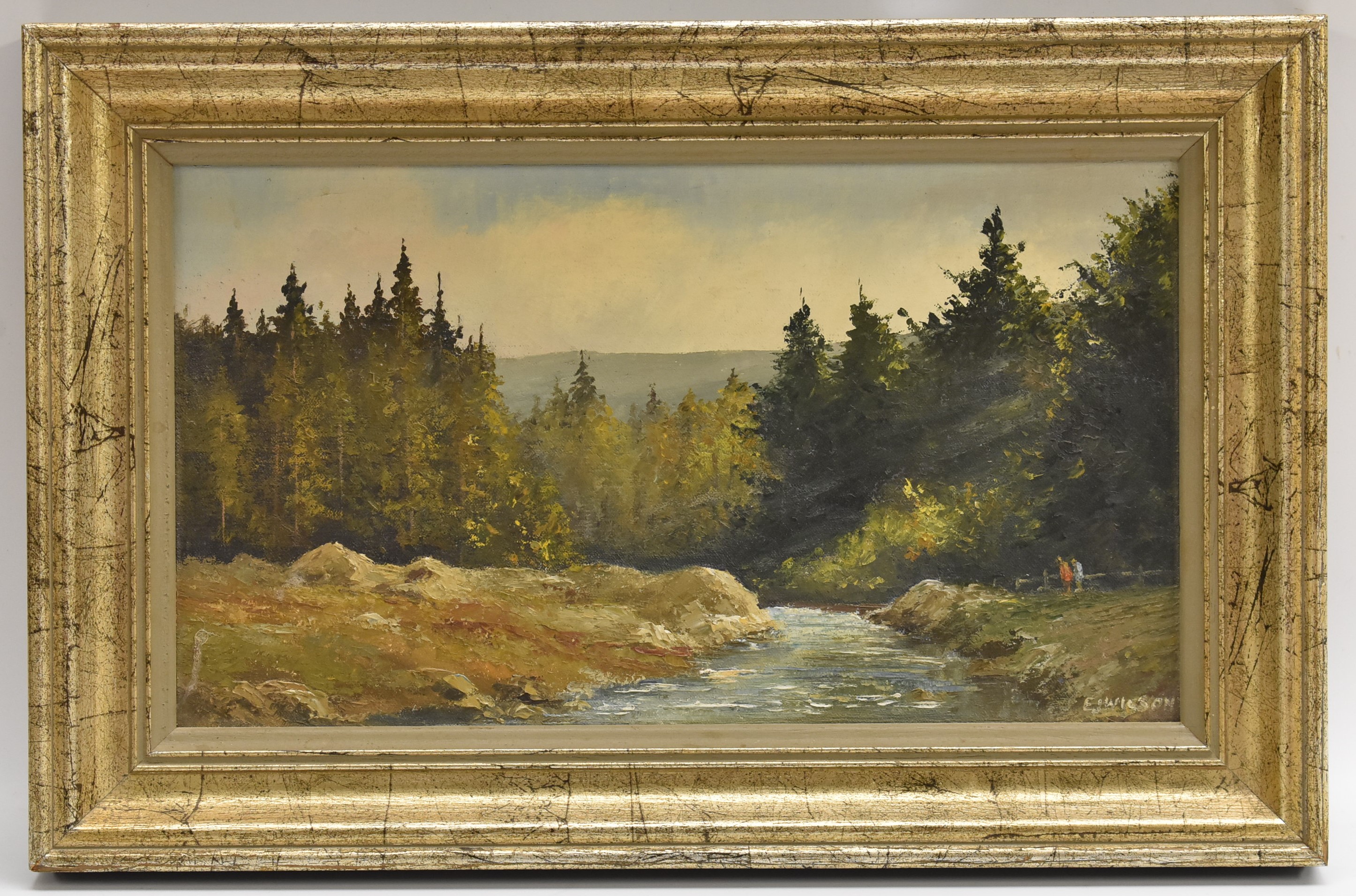 E J Wilson Amongst the Pines, Figures Beside a Busy Stream signed, oil on board, 18.