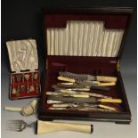 A walnut box containing mother of pearl handled flatware;