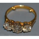 A diamond trilogy ring, central round old brilliant cut diamond approx 1.
