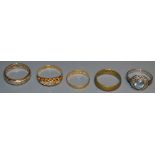Three dress rings; 22ct gold wedding band; another,
