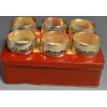 A set of six silver napkin rings in a OXO tin