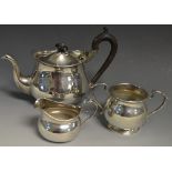 A silver three piece tea service, scroll handles,