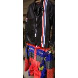 A TT Leathers motorcycle suit, black with red, white and blue striped detail; another,