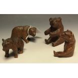 A group of four small Black Forest carved bears,