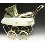 A vintage Tri-ang tin plate dolls pram, white body and spring cradle, double folding canopy,