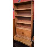 A light oak open bookcase;